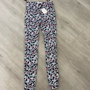 Atmosphere zipper straight leg leggings. Black with pink, blue and white flowers